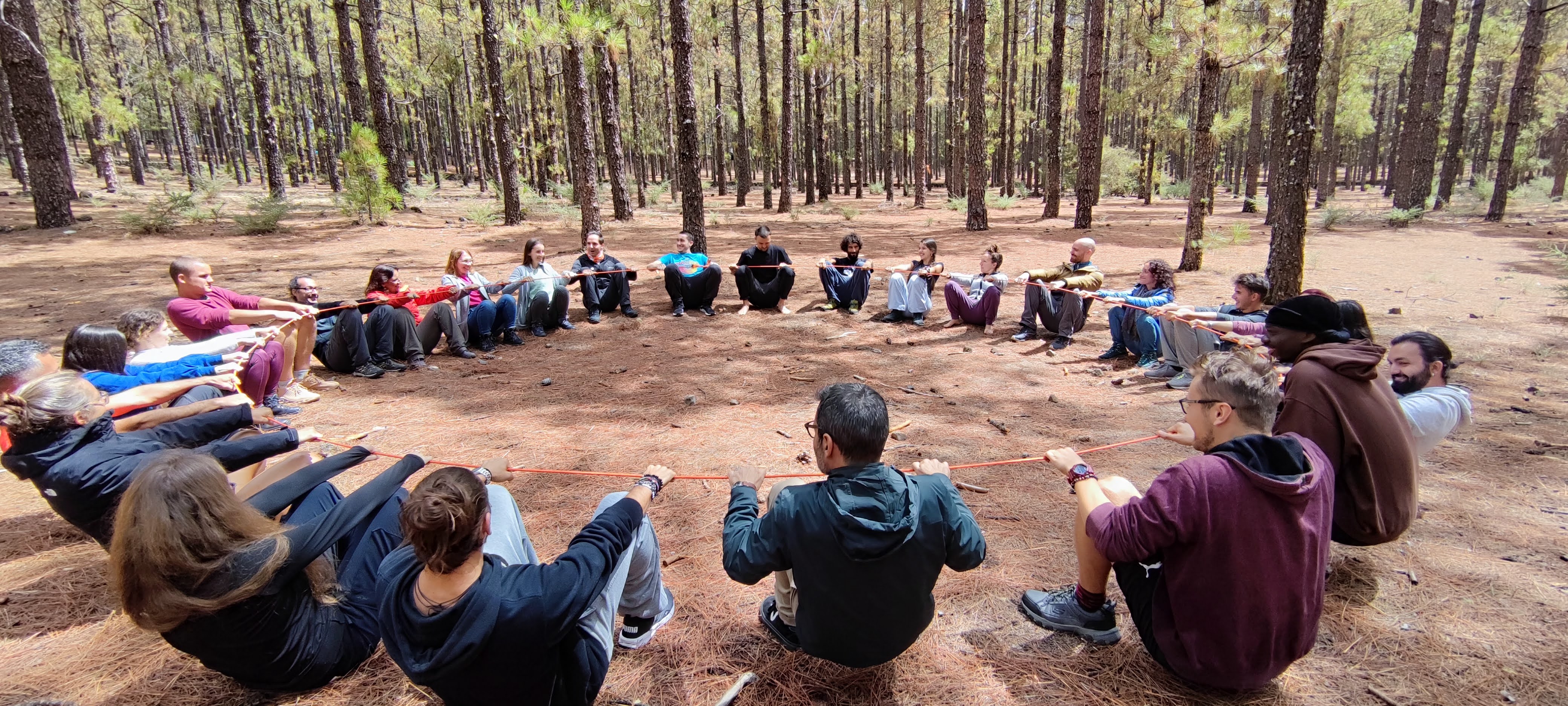 A group of young people and facilitators sitting in a circle during a session