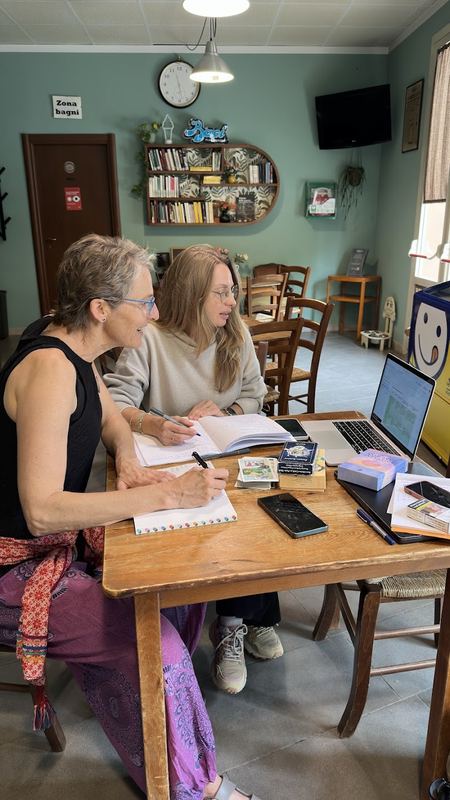 Two team members co-working on a laptop