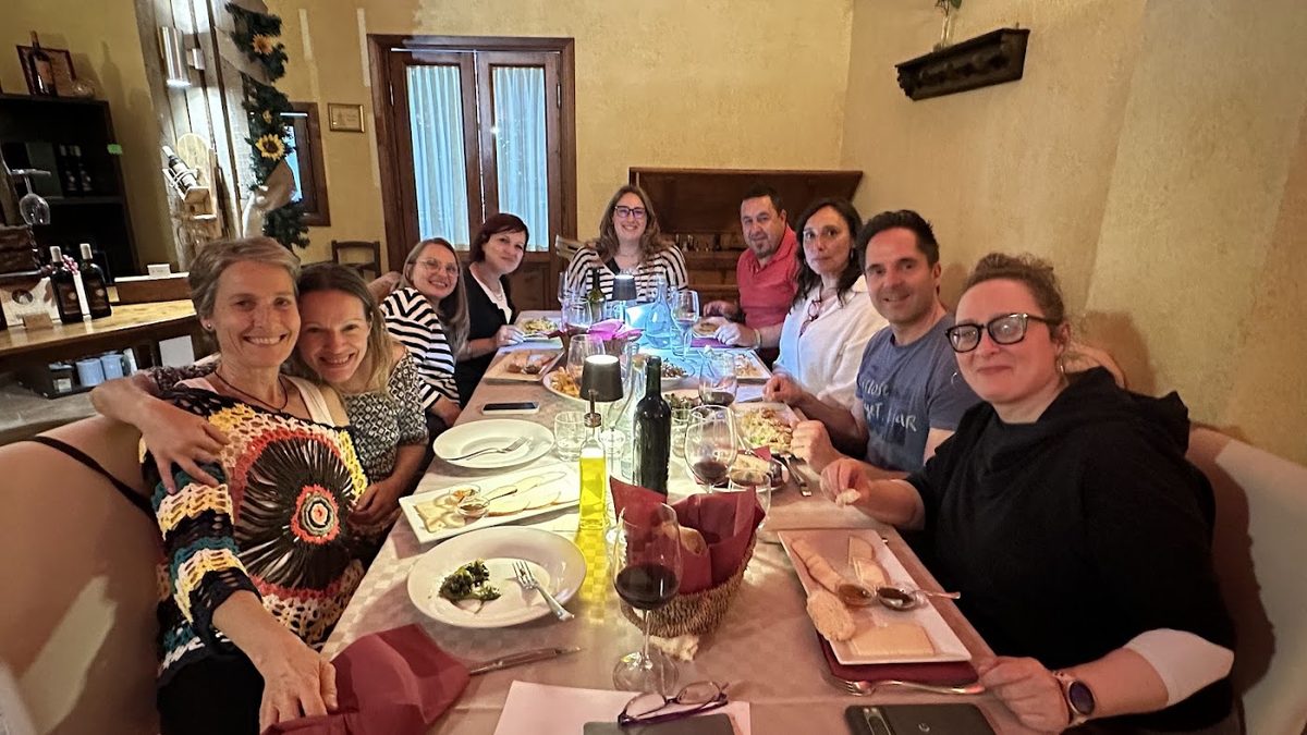 The whole consortium sharing dinner around a long table